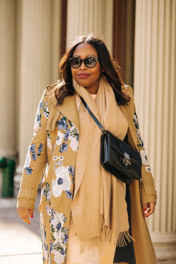 Sade Strehlke in a Rodebjer salmon-colored dress and brown J.W. Anderson boots from Hampden and an Erdem embroidered coat, finished with a handbag and sunglasses by Celine.