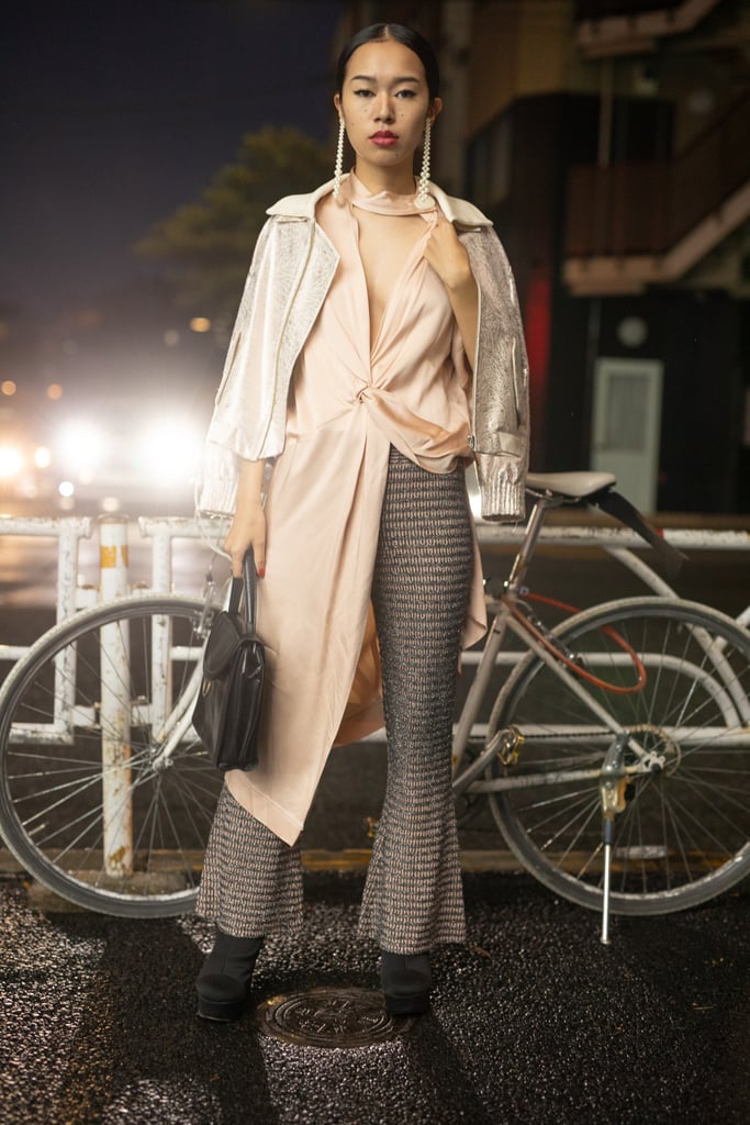 Wear a lightweight champagne top over flared pants and thick boots. Complete with a metallic coat and drop earrings.