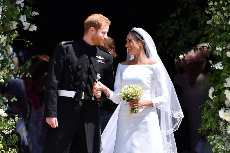 TOPSHOT - Britain's Prince Harry, Duke of Sussex and his wife Meghan, Duchess of Sussex emerge from the West Door of St George's Chapel, Windsor Castle, in Windsor, on May 19, 2018 after their wedding ceremony. (Photo by Ben STANSALL / various sources / A