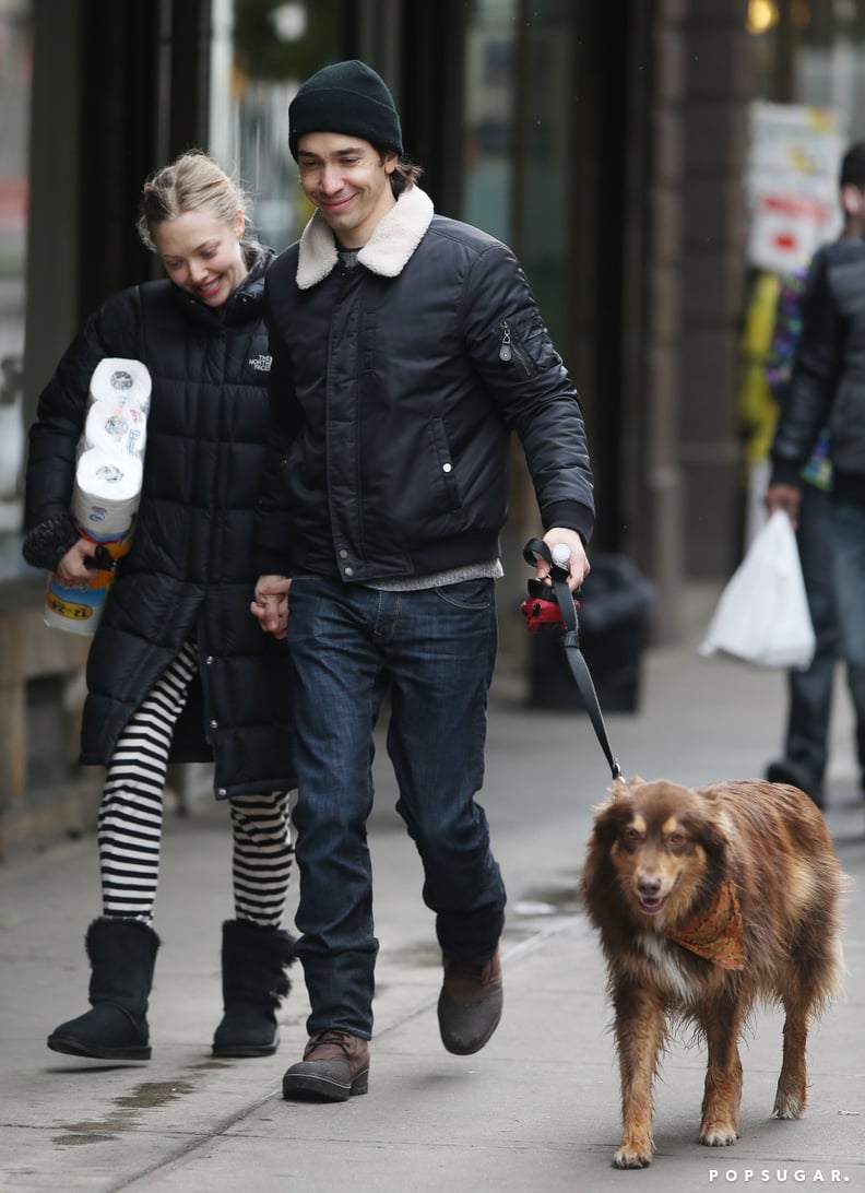 They hold hands while walking her dog.