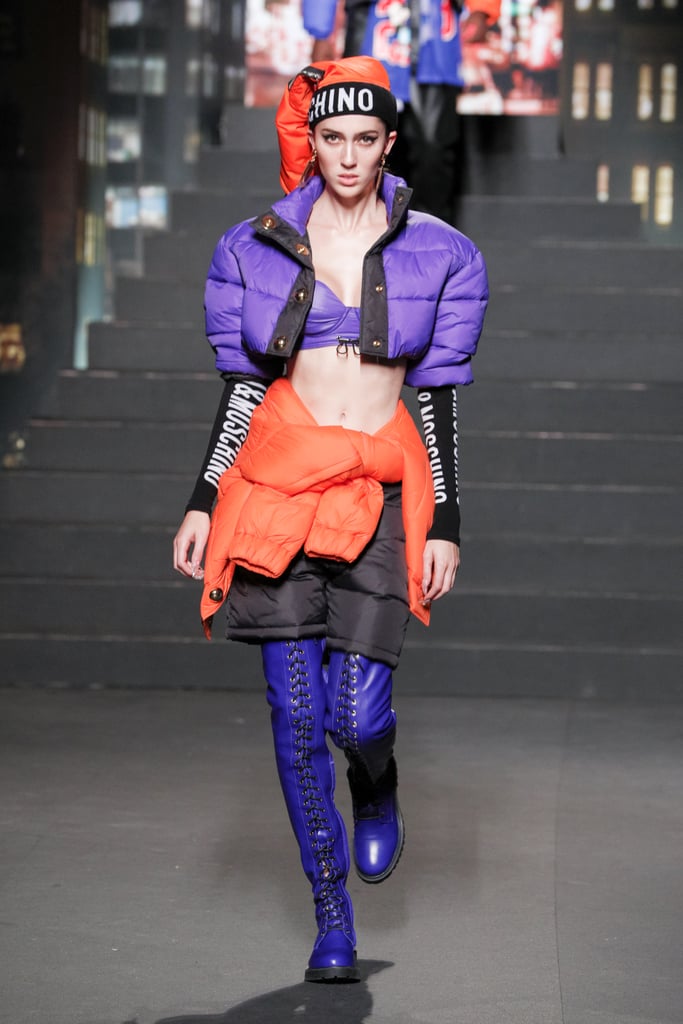 A Model Wearing a Cropped Puffer With Purple Thigh-High Boots