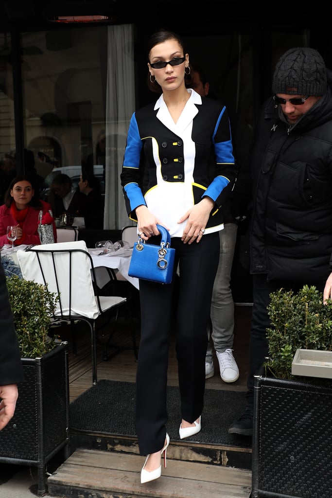 Wearing a sporty colorblock pantsuit with a Dior mini bag and tiny sunglasses. She finished off her look with Christian Louboutin heels.
