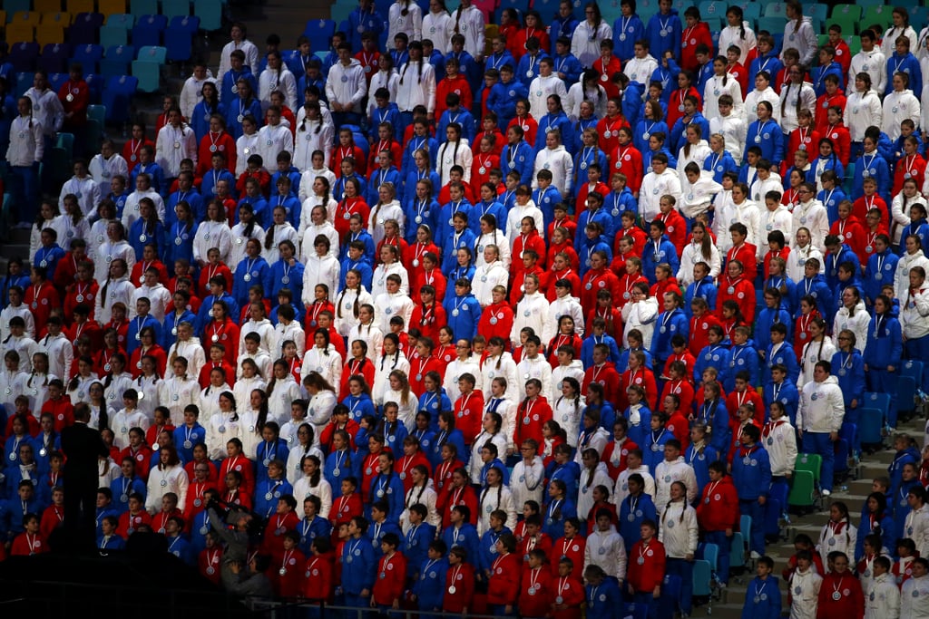 Children in red, white, and blue watched from the stands.
