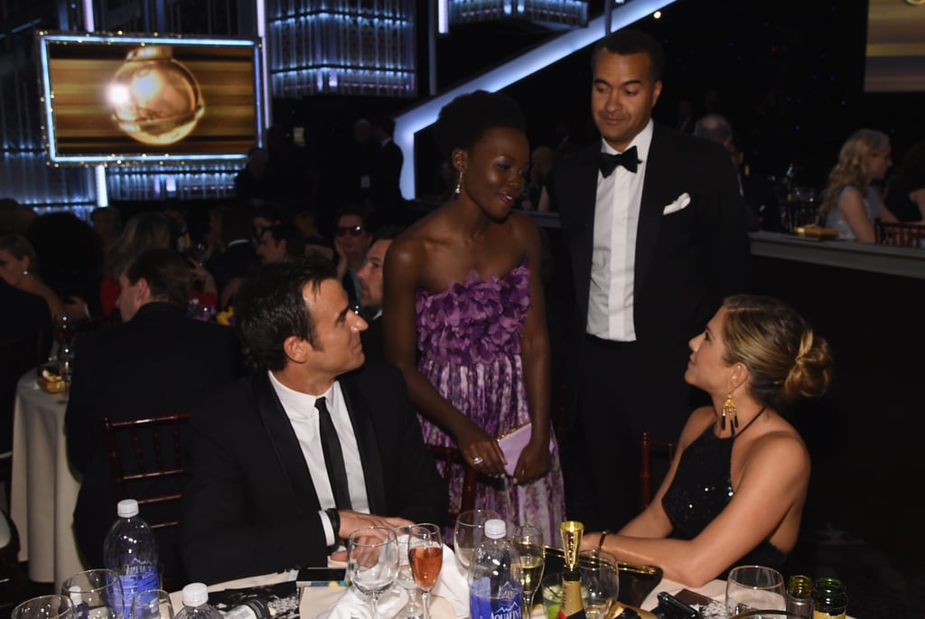 Lupita Nyong'o stopped by Jennifer Aniston and Justin Theroux's table for a chat.