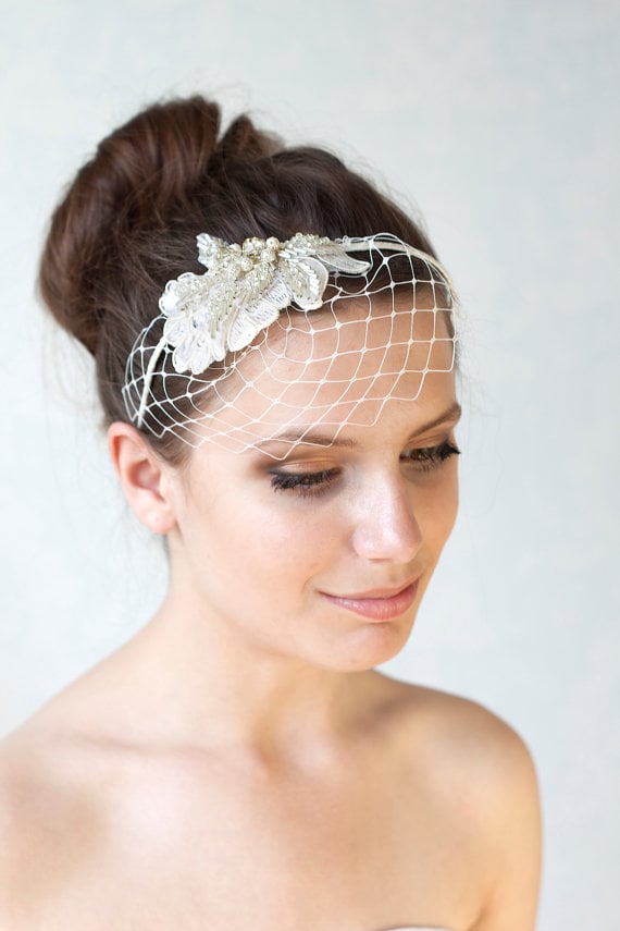 A bridal ivory birdcage veil headband (55) is simple and sweet, and