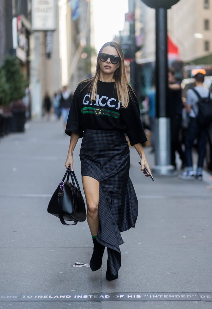 This street style star convinced us all to invest in a Gucci shirt just so we can tuck it into our asymmetrical navy skirt.