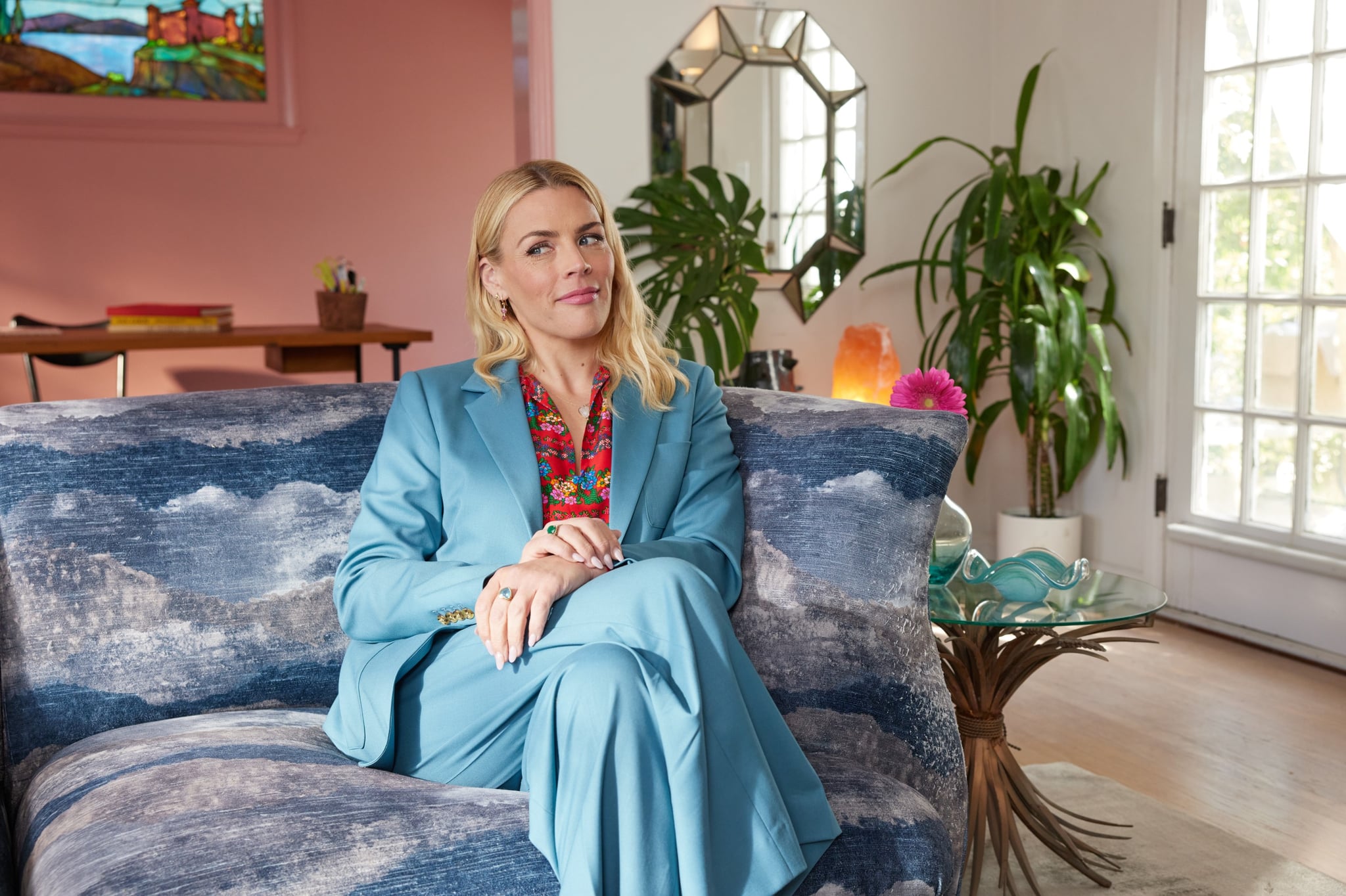 Busy Philipps sitting on the couch in her living room.