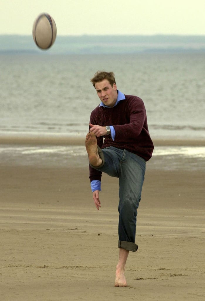 The royal played with a rugby ball during a trip to the beach in May 2003.