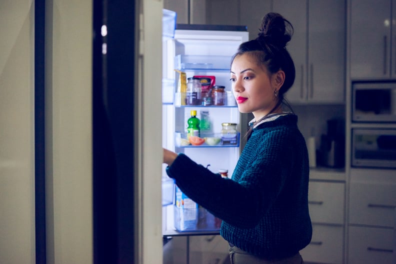 Young Beautiful Woman Searching For Food In The Fridge. Late night snack.  Beautiful woman opening the
