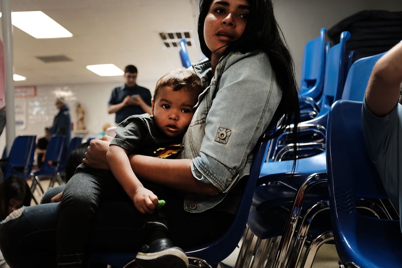 MCALLEN, TX - JUNE 21: A woman who idendtified herself as Jennifer sits with her son Jaydan at the Catholic Charities Humanitarian Respite Center after recently crossing the U.S., Mexico border on June 21, 2018 in McAllen, Texas. Once families and individ