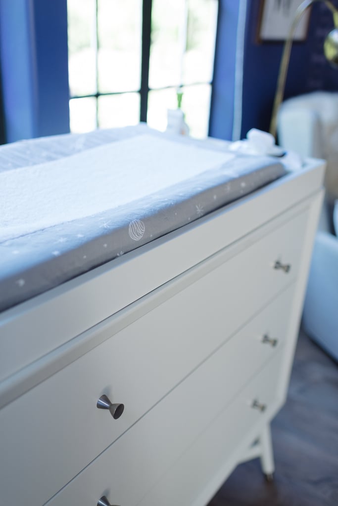 The Galaxy Changing Pad Cover ($26, originally $32) was a perfect fit for Holt's changing table. The changing pad is nestled within a Mid-Century French White Changing Top ($99).
