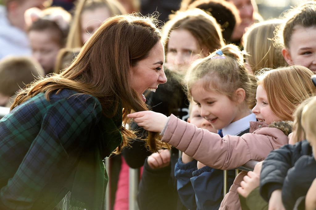 Kate laughed as a little girl touched her famous blowout during a visit to Dundee, Scotland in January 2019.