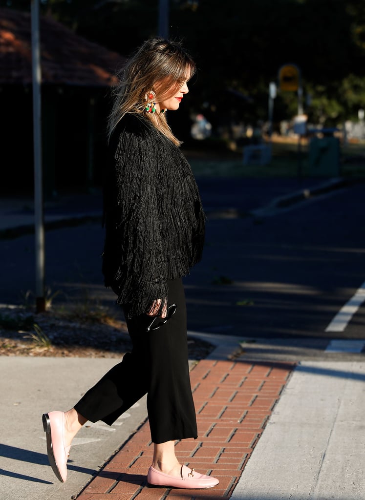 A sugar-pink loafer will lighten up any all-black outfit, especially with the help of gemstone statement earrings.