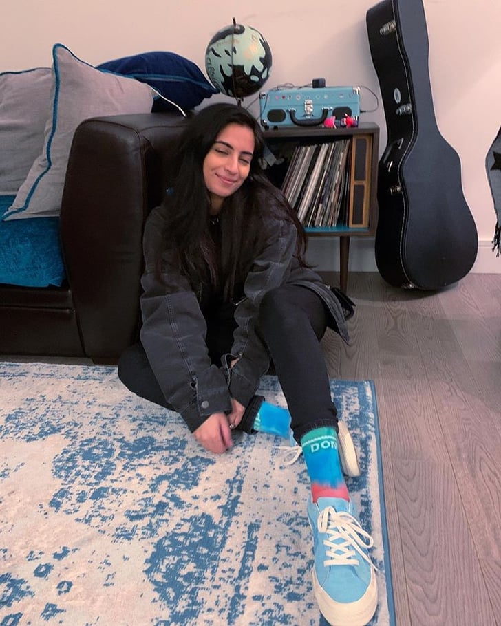 Styling tie-dye socks with a shearling-lined denim jacket, skinny jeans, and Converse x Golf le Fleur sneakers.