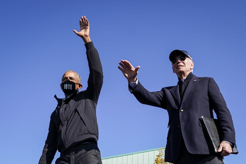 FLINT, MI - OCTOBER 31: Former U.S. President Barack Obama and Democratic presidential nominee Joe Biden wave to the crowd at the end of a drive-in campaign rally at Northwestern High School on October 31, 2020 in Flint, Michigan. Biden is campaigning wit