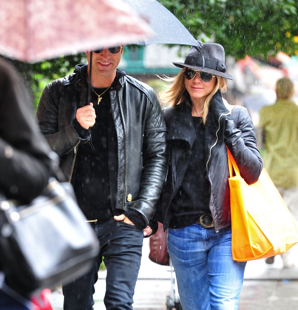 Justin held an umbrella over the couple as they ventured out during a rainy NYC day in September 2011.