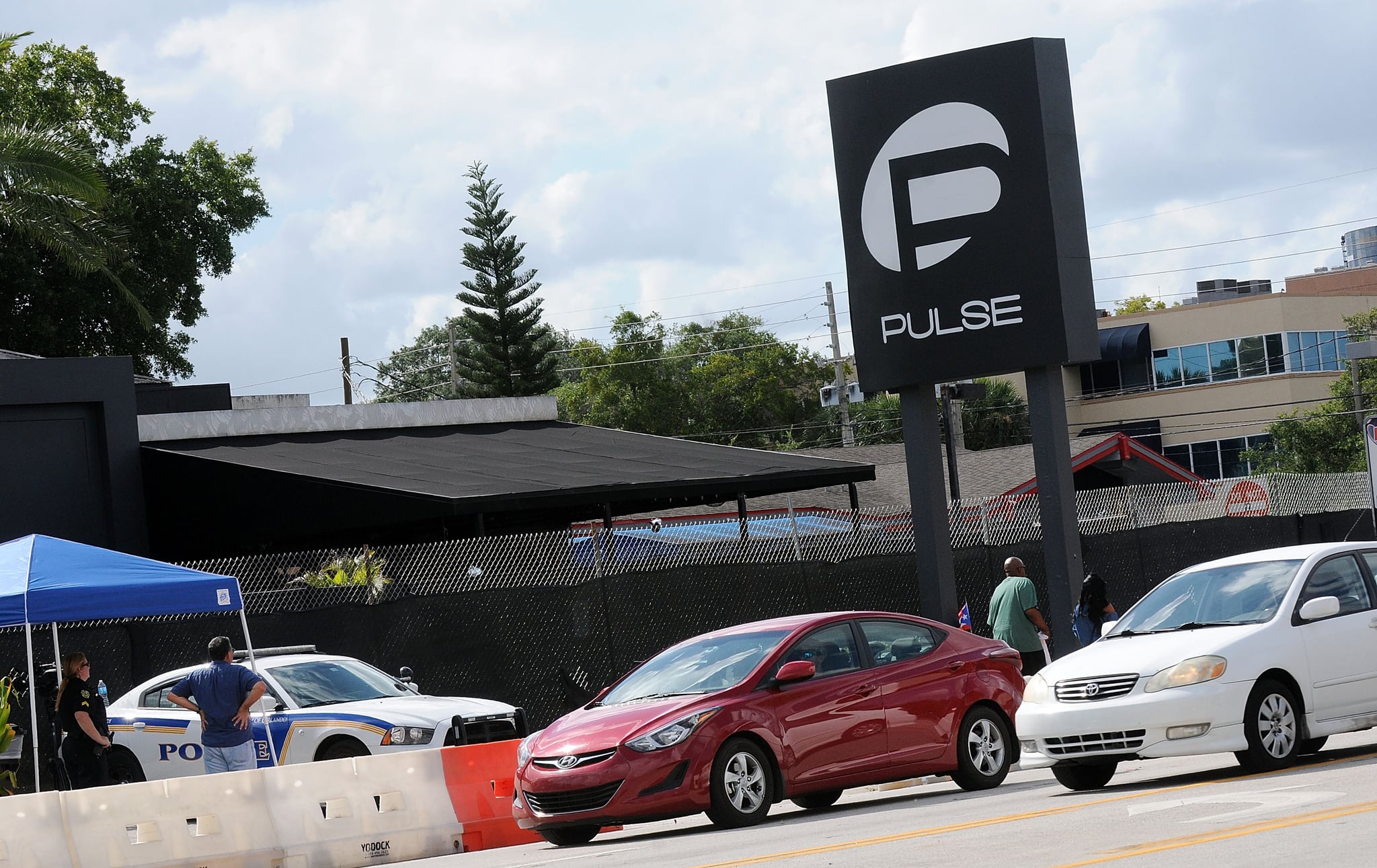 ORLANDO, FLORIDA - JUNE 21:  Vehicles cross in front of the Pulse Nightclub on June 21, 2016 in Orlando, Florida. Orlando community continues to mourn deadly mass shooting at gay club.  The Orlando community continues to mourn the June 12 shooting at the Pulse nightclub in what is being called the worst mass shooting in American history, Omar Mir Seddique Mateen killed 49 people at the popular gay nightclub early last Sunday. Fifty-three people were wounded in the attack which authorities and community leaders are still trying to come to terms with. (Photo by Gerardo Mora/Getty Images)