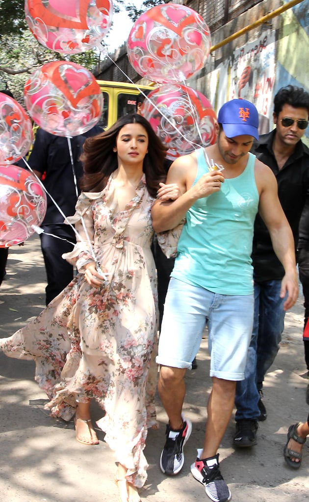 Walking the street with fellow actor Varun Dhawan in a long floral gown.