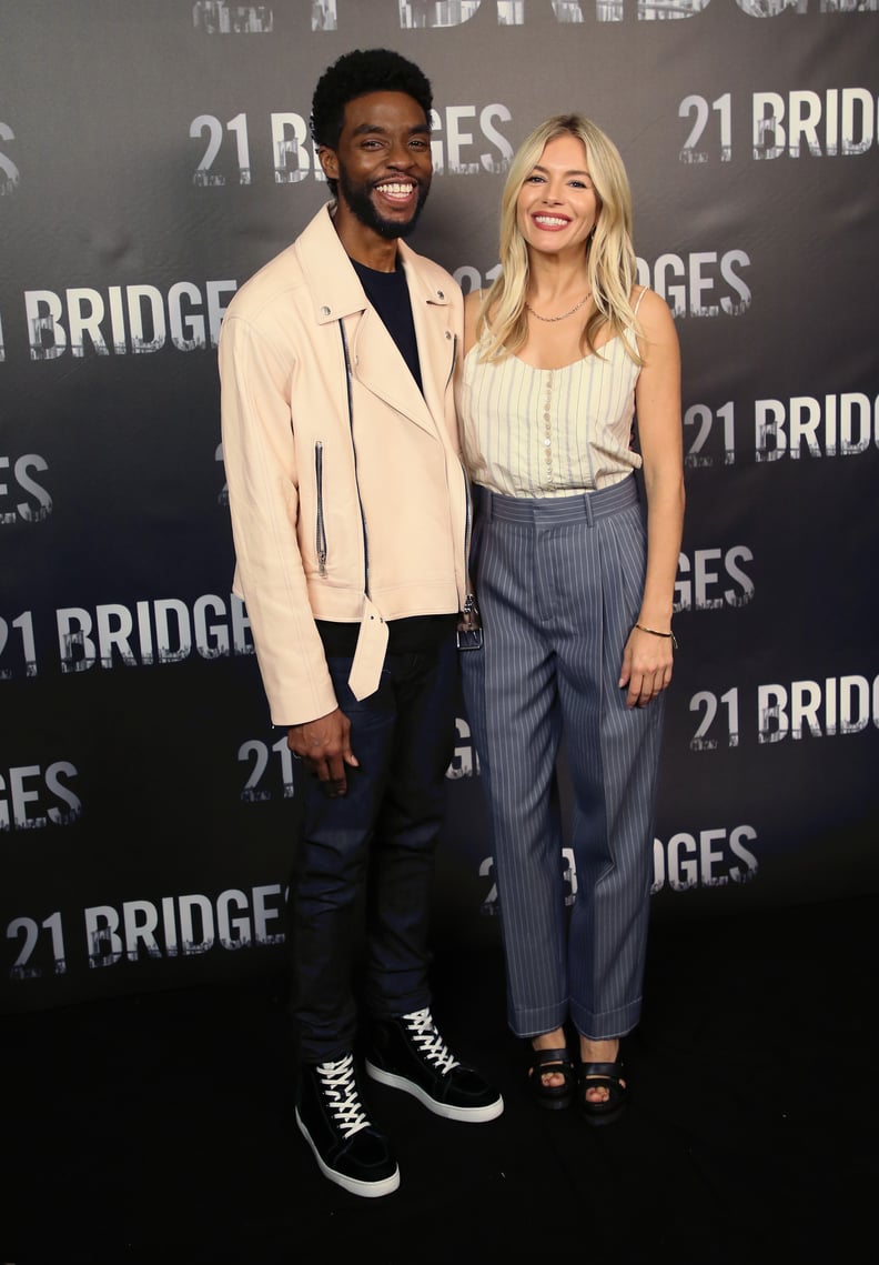 LOS ANGELES, CALIFORNIA - NOVEMBER 09: Chadwick Boseman and Sienna Miller attend a photocall for STX Entertainment's 