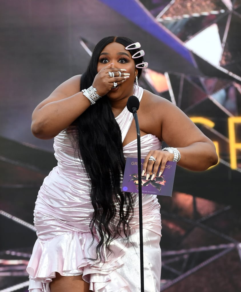 The 2021 Grammy Awards might've announced the majority of the winners before the show even started, but when Lizzo took the outdoor stage to present the first live winner, she did not disappoint. On March 14, the three-time Grammy winner was overwhelmed with emotion as she presented best new artist, and who could blame her?! Lizzo, per usual, was a straight-up relatable queen as she slipped out a swear when gracing the stage. "B*tch, I'm back!" she said with the envelope in hand. 
Now about that envelope . . . just like me when I'm under the slightest bit of pressure and there's no fidget spinner to save me, Lizzo dealt with a slight fumble struggling to open it. "I'm nervous, y'all, I'm shaking, and it's not even my award! Wait, how do you open it?" she said. 
And when she did open it to see Megan Thee Stallion's name, she immediately lit up with pride. It was a must-see Grammys moment that had me cheesing from ear to ear. One person said it best on Twitter, writing, "Lizzo not knowing how to open the letter and megan just sitting there when she won the grammy are both moods." It's the cute nervous energy for me! Watch the sweet moment here, and check out photos of Lizzo presenting at the Grammys ahead.

    Related:

            
            
                                    
                            

            Megan Thee Stallion Dedicates Historic Grammys Win to Late Mother: "She&apos;s Here in Spirit"