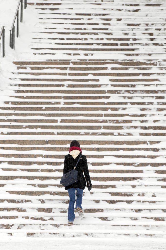 In Boston, MA, a woman made her way up the snowy City Hall steps.