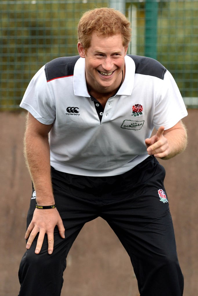 Prince Harry got into the competitive spirit with a group of schoolchildren at a Monday morning rugby game in Manchester, UK.