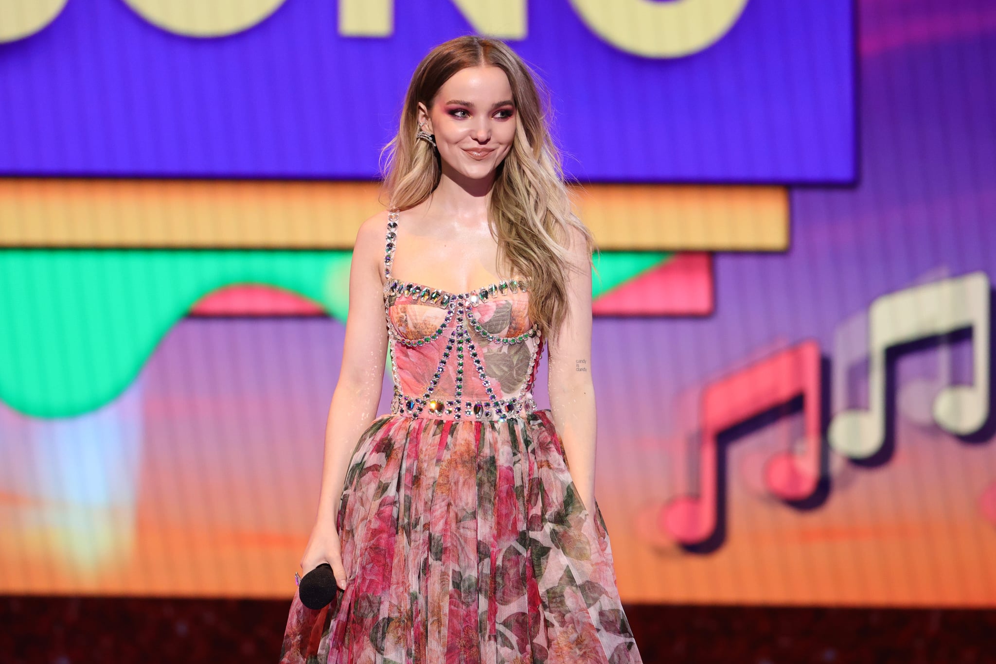 SANTA MONICA, CALIFORNIA - MARCH 13: In this image released on March 13, Dove Cameron speaks onstage during Nickelodeon's Kids' Choice Awards at Barker Hangar on March 13, 2021 in Santa Monica, California. (Photo by Rich Fury/KCA2021/Getty Images for Nickelodeon)