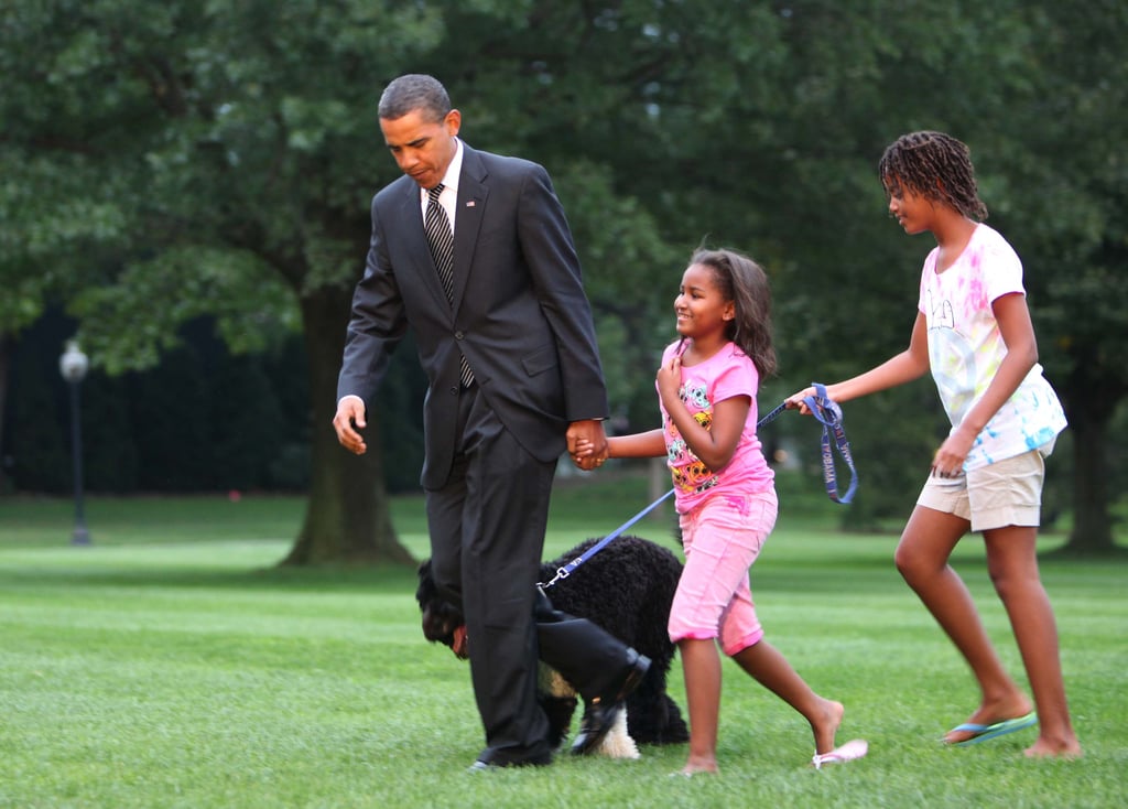 Talk about a warm reception! After returning from a trip to Ohio and Pennsylvania, the president was greeted by Sasha, Malia, and a very eager Bo.