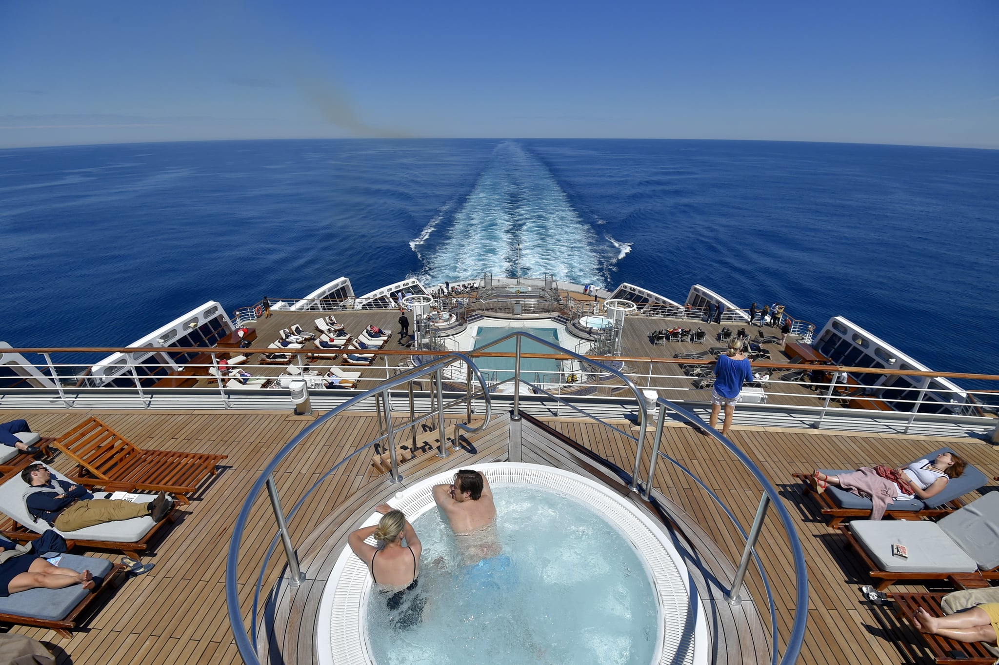 People sunbath in a hot tub aboard of a cruise ship.