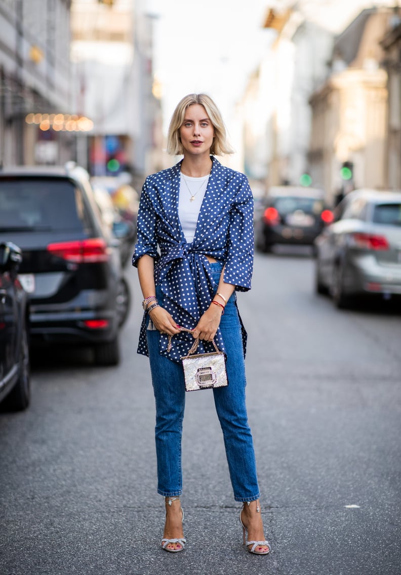 With a White Tee, a Polka-Dot Shirt, White Heeled Sandals, and a Small Crossbody Bag