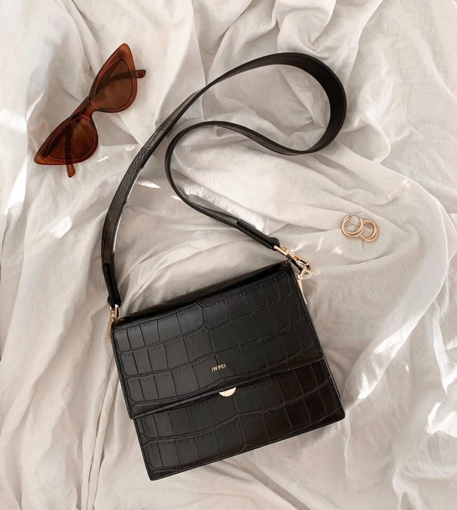 JW PEI Women's Mini Flap Crossbody ($64, originally $80)
Isn't this bag so perfect for fall? The croc texture feels right on trend, but if the black isn't your thing, there are other versions on sale, too — including a beige canvas-and-vegan-leather style and a sleek smooth vegan leather one. Find out why one of our former editors was obsessed in our JW PEI Women's Mini Flap Crossbody review.
Editor Quote: "There's a reason I carry this bag everywhere I go. Clocking in at just under eight inches long, this purse has ample room for my wallet, phone, keys, and hand sanitizer — but it's not so big that I have to spend an embarrassing amount of time locating a mere tube of lipstick. The bag's flap closure makes it easy to access to my belongings, not to mention there are two compartments so I can stay somewhat organized. And, thanks to the nearly 17-inch strap, I have a hands-free way to keep all my belongings nearby." — Kelsey Mulvey, former contributing shopping editor