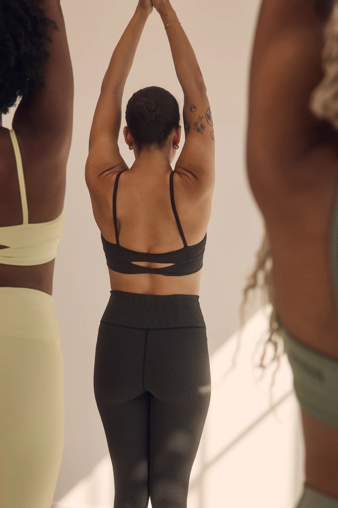 Spiritual Gangster Auralight Legging ($108)
If you prefer gentle compression that lifts and sculpts, these leggings are for you. They have the brand's AuraLight rib detail, with a slightly shimmering effect. Perfect for yoga or hiking, they'll earn you plenty of compliments from the front and back.
Pros: It's rare to find a pair of compression leggings that are flattering and butt-lifting in ethereal colors like these. The waistband is also contoured for extra support.
Cons: One reviewer reports the yellow colorway to be a bit off from the photo.
Material: Nylon, spandex.
Length: 7/8
Colorways: 3
Sizes: XS-XL
Who it's best for: People who love colored sets and prefer low-impact exercise.
Extras: They have an interior stash pocket for when you're on the go.
What Reviewers Say: "Love the style, but giving 3 stars because the yellow looks more butter yellow in this photo and I bought the yellow shirt to match that also looks butter yellow in the photo. Even though all 3 items say French Vanilla for color, this bra/leggings set is more lemon yellow in real life and doesn't match the leggings/bra. I own lemon yellow shirts that will match, but disappointing when you purchase an outfit to go together and can't wear it together."