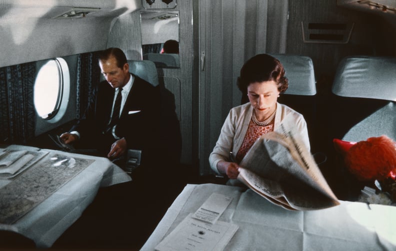 Queen Elizabeth II reading papers on a plane in 1969.