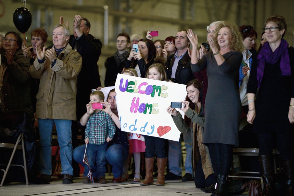 Family members took pictures and held up signs as the group returned.
