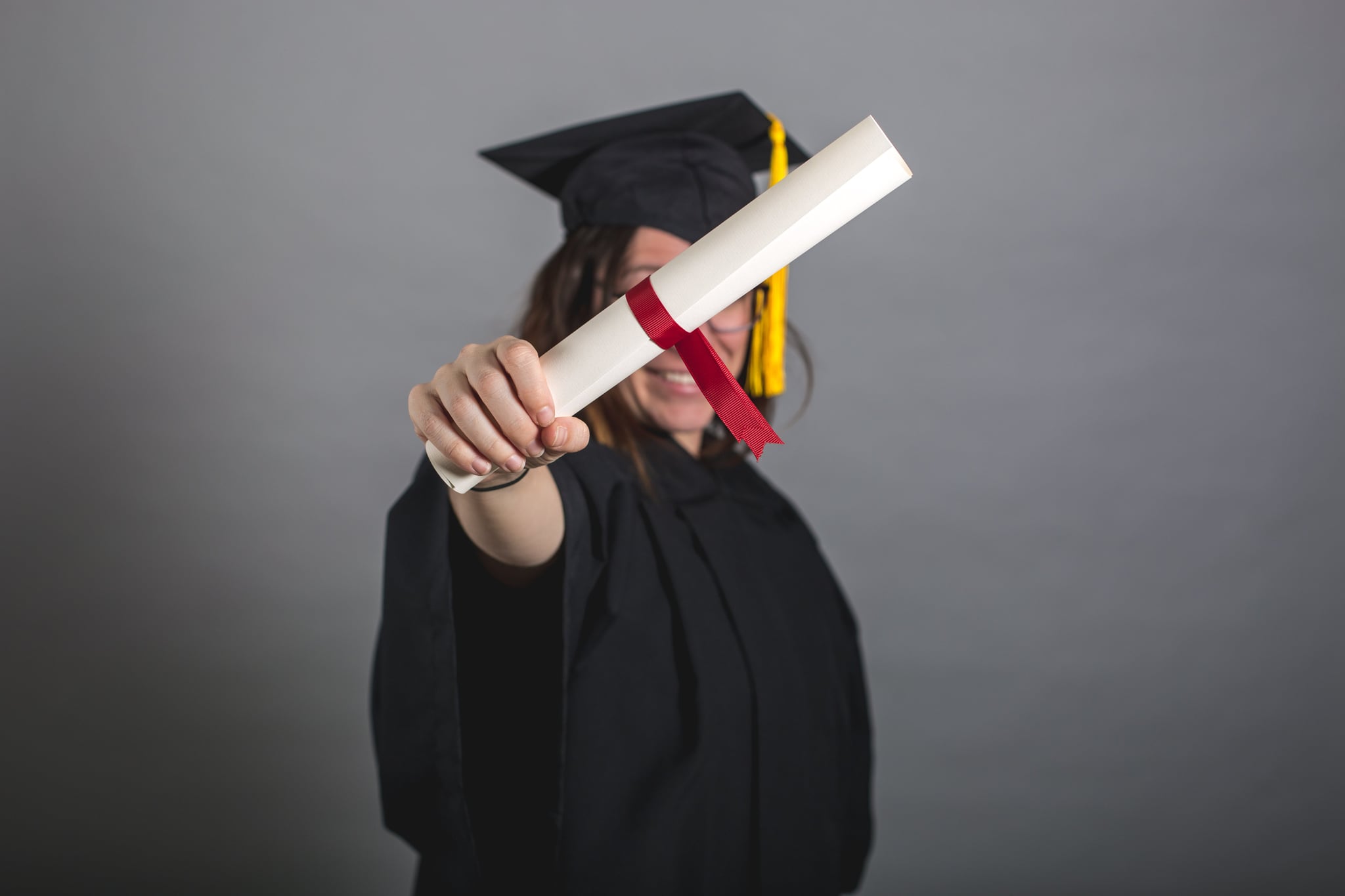 tmp_oxeavi_8c9ae543017ee04d_female-grad-student-holding-out-diploma.jpg