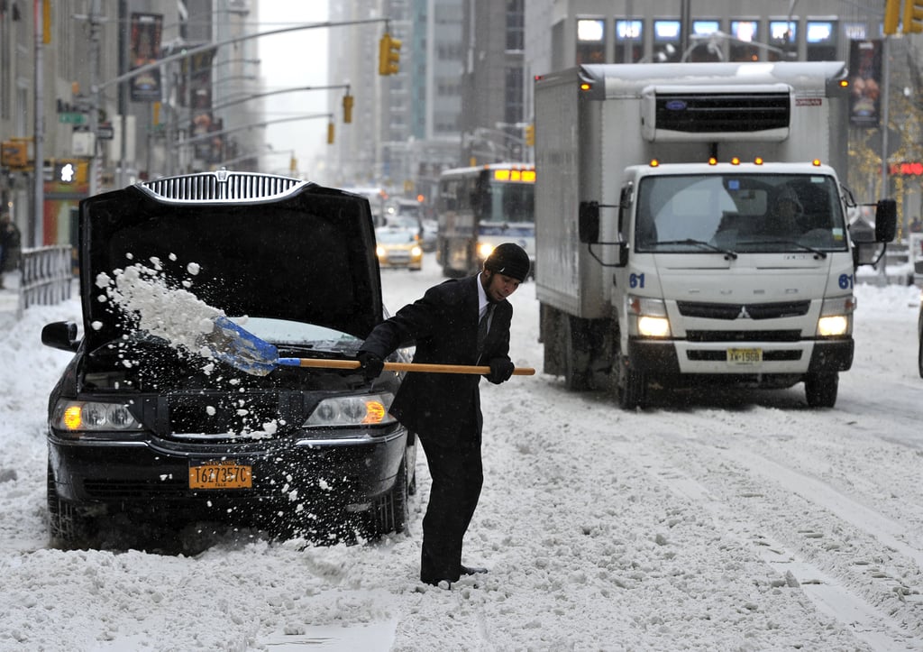 A man dug his limo out of the snow on NYC's 6th Avenue.