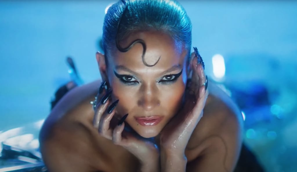 She Wears a Slick, Metallic, Asymmetrical Design She Wears a Slick, Metallic, Asymmetrical Design