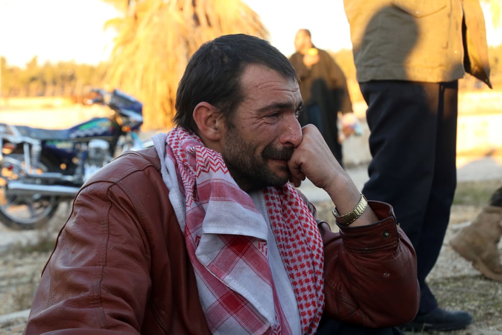 A Syrian man cries after he's evacuated from Aleppo and arrives at the military-controlled Khan al-Aassal region on Dec. 15.