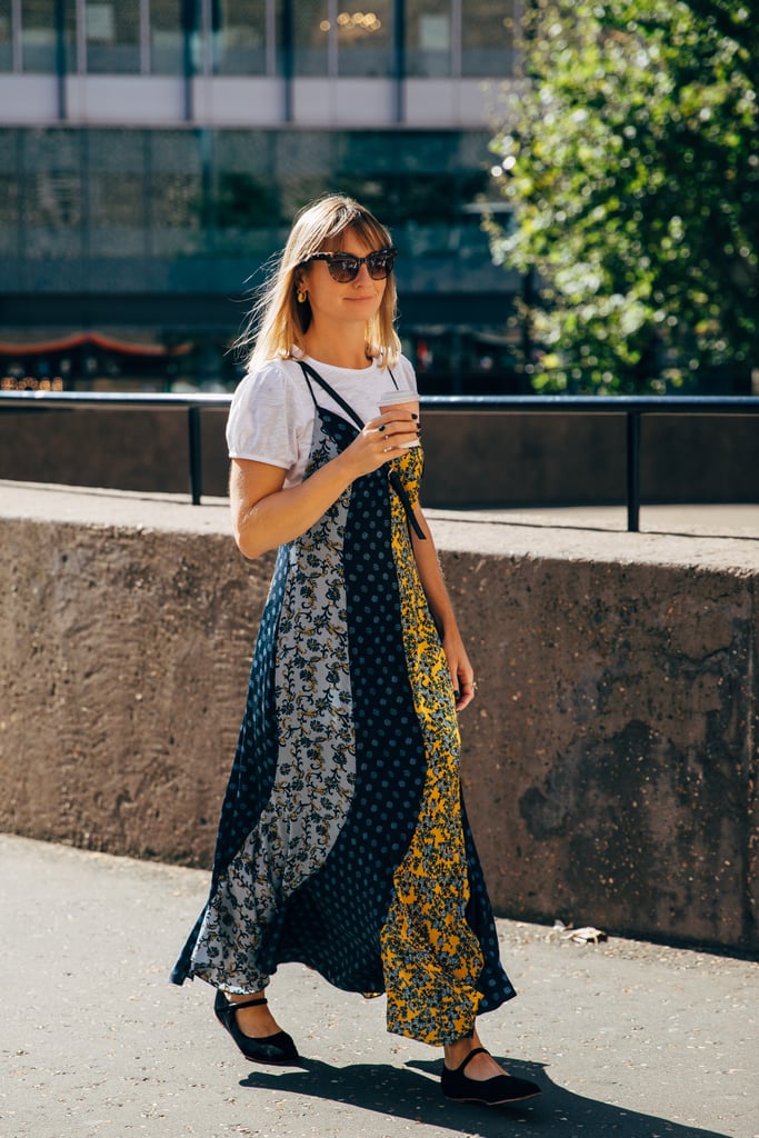 Layer a busy printed dress over a white tee and add a crossbody bag to keep your look grounded.