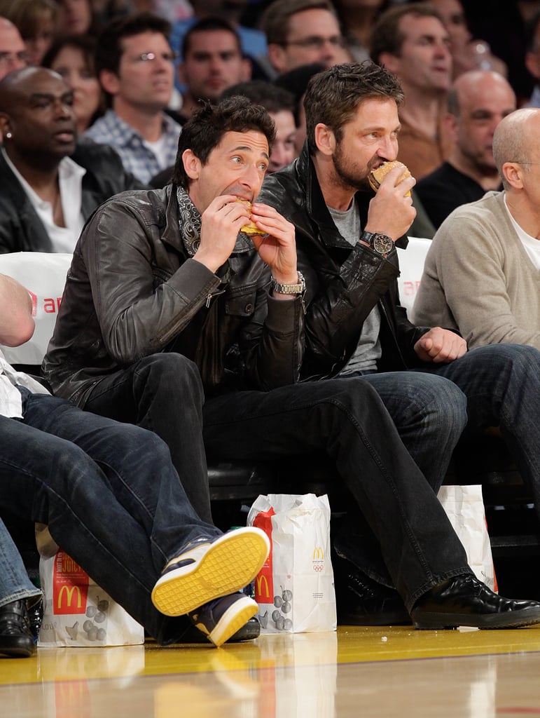 Adrien Brody and Gerard Butler chowed down on burgers while watching a Lakers game together in March 2010.