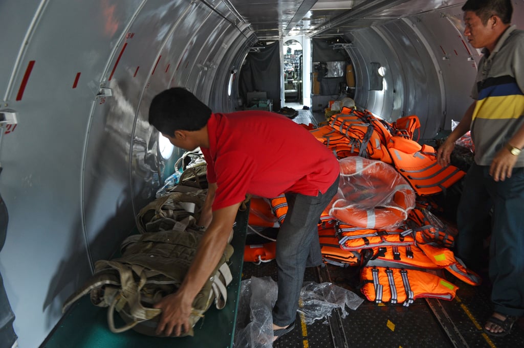 Personnel inspected life jackets on a search and rescue plane.
