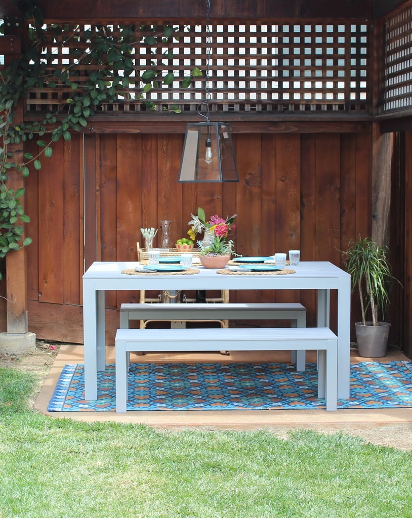 Tip #2: Introduce Pattern With Rugs 
Nothing draws the eye like a beautiful, bold rug — especially when the rest of the outdoor space is fairly minimal. World Market has so many vibrant options, but this Barcelona-inspired version ($150) mimics the intricacy of Spanish tiles. If you yearn for the look of gorgeous, graphic tile but can't splurge on the renovation cost, this is the next best thing!