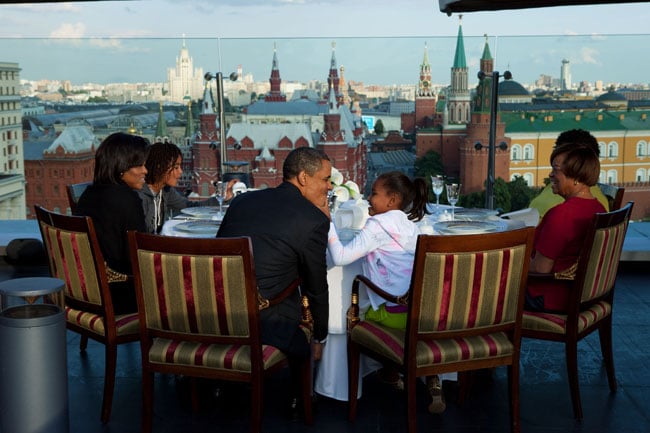 Sasha goofing off with her dad while the first family takes in a view of the Kremlin in Moscow at dinner.
