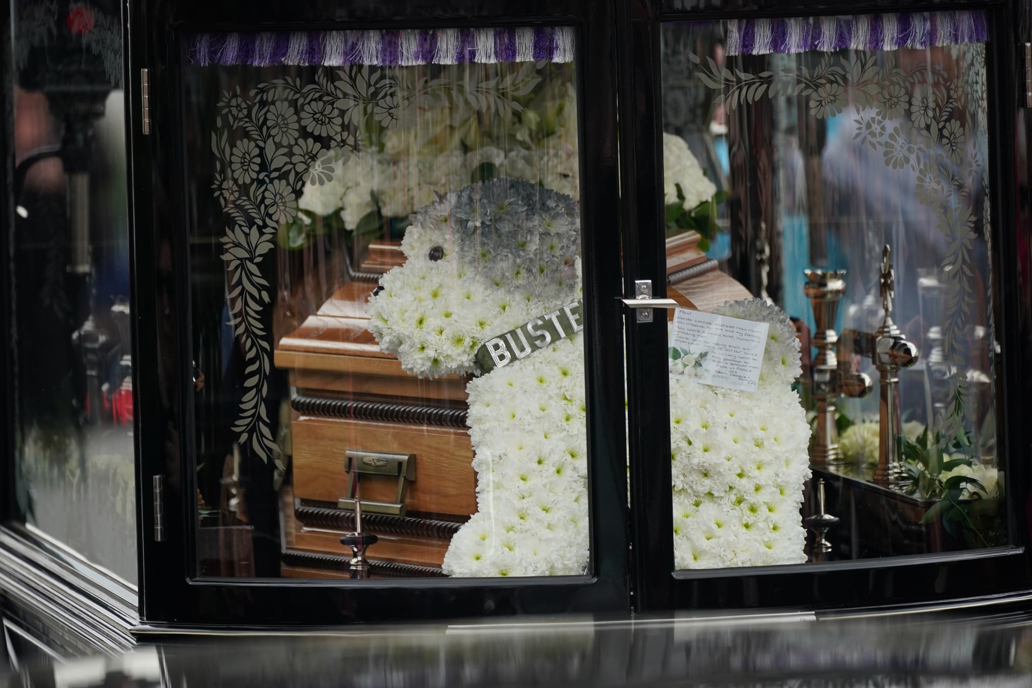 Floral tributes on the funeral cortege of Paul O'Grady travels through the village of Aldington, Kent ahead of his funeral at St Rumwold's Church. Picture date: Thursday April 20, 2023. (Photo by Yui Mok/PA Images via Getty Images)