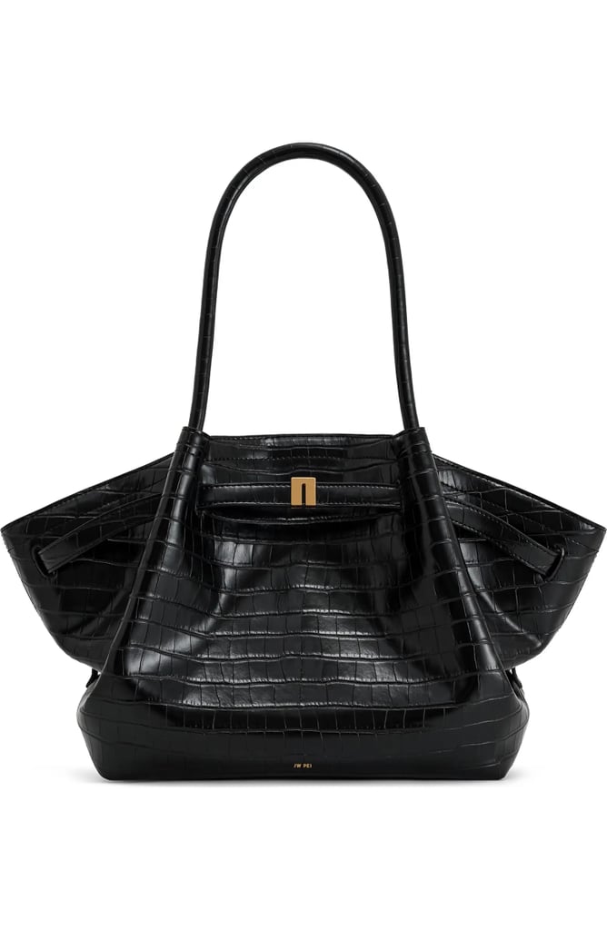 JW Pei Hana Croc Embossed Faux Leather Tote ($149)
"I've been looking for a chic work bag for the longest time, and JW Pei's latest Hana tote is heavy on my radar. It's made from water-repellent, faux croc leather, which will make it ideal for various weather conditions. I also love its trapezoid-like shape, making it versatile to pair with any outfit for the office or on the go." — Naomi Parris, assistant shopping editor
