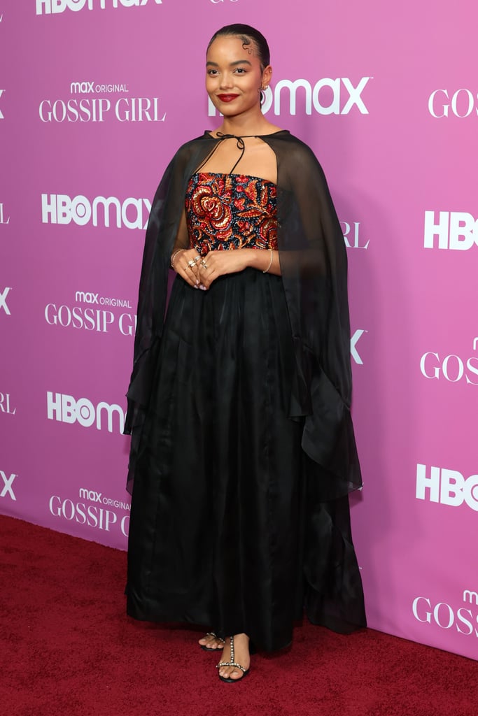 The new Gossip Girl cast finally made their red carpet debut at Wednesday night's NYC premiere, as if we weren't already so hyped for the reboot airing July 8. While every member of the fresh crew was dressed to the nines, one look in particular that stood out was Whitney Peak's head-to-toe Chanel ensemble, only appropriate for a newly minted member of Manhattan's elite. The actress, who plays Zoya Lott, walked the red carpet wearing a gorgeous embroidered bustier dress with a matching organza cape from Chanel's pre-fall 2021 collection. And as a Chanel ambassador, Whitney was naturally sporting jewelry, shoes, and even makeup from the luxury brand. 
I don't know about you, but the vampy vibe immediately reminded me of none other than Jenny Humphrey, who, interestingly enough, many fans have been comparing Zoya to since more details of the reboot have emerged. Perhaps Whitney wanted to give a subtle shout-out to her inspo ahead of the show? For what it's worth, I could totally picture Little J wearing something like this to cotillion. Regardless, Whitney certainly exuded the energy of a new It girl in her statement look. Ahead, see close-ups of the budding star's red carpet outfit. 

    Related:

            
            
                                    
                            

            Jordan Alexander&apos;s Red Carpet Outfit Begs the Question: What If Brides Wore Low-Rise Pants?