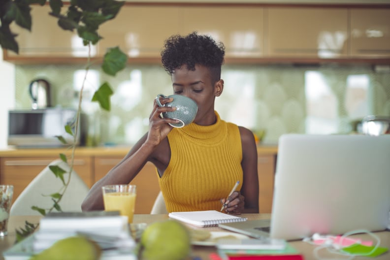 Young woman is drinking and making a budget