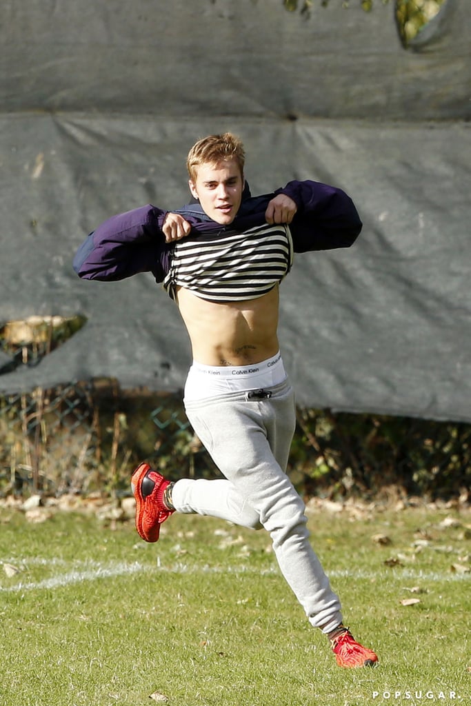 Justin Bieber showed off his Calvins while joining a group of high school students for a soccer match in North London on Wednesday. The singer, who is in town for his run of shows at the O2 Arena, reportedly drove by a school in Highgate with his manager Scooter Braun and stopped to jump into the PE class. While hitting the field with the 11th-graders, Justin lifted up his shirt and gave a flash of his abs. "I recognized him straight away. They had been driving past and seen our lesson going on," said teacher Mario Noto. He continued, "We thought this would be a great experience for the pupils. He was very down to earth and could have been another pupil, just enjoying himself, and spent about half an hour with us. He asked me to go in goal for a few penalties — and turned out to be pretty good!"