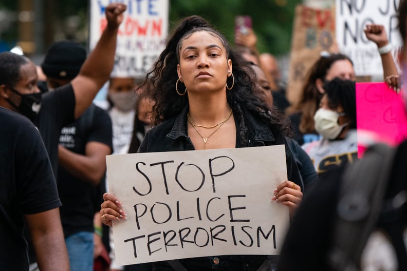 Qri Montague holds a sign while marching following the guilty verdict the trial of Derek Chauvin on April 20, 2021, in Atlanta, Georgia. - Derek Chauvin, a white former Minneapolis police officer, was convicted on April 20 of murdering African-American Ge