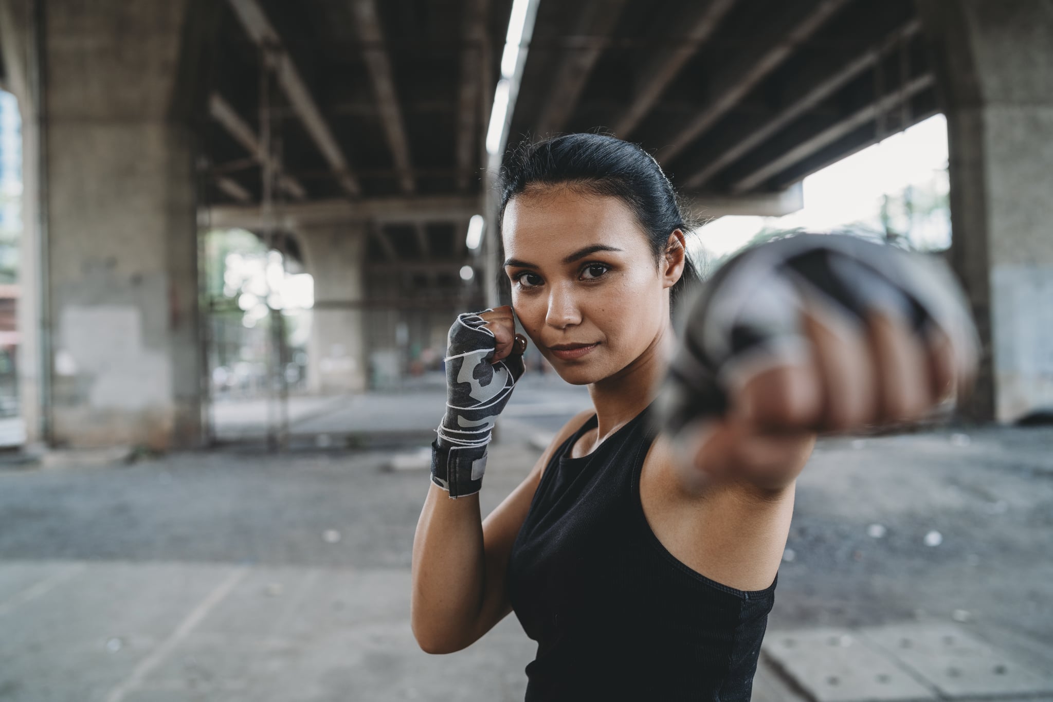 Powerful young woman punching. Thailand, Bangkok